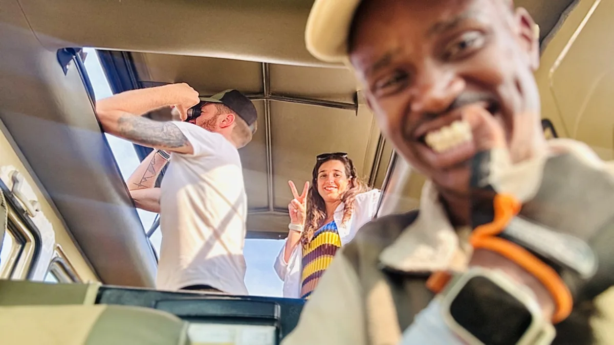 Guests smiling together inside the safari vehicle